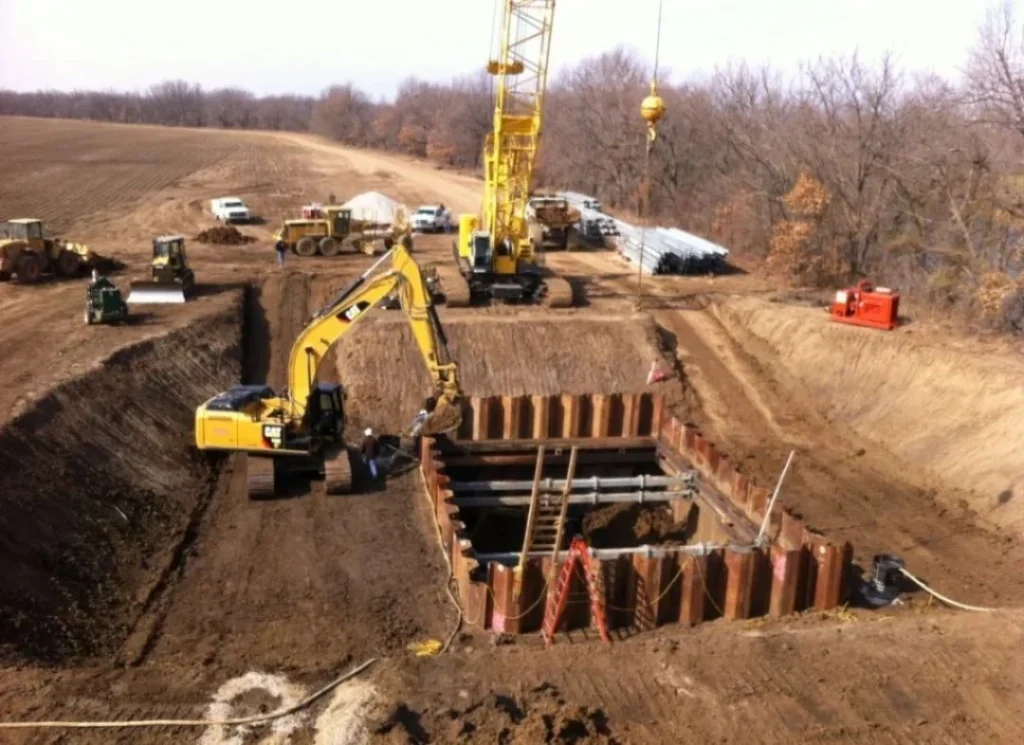 Excavator digging trench.