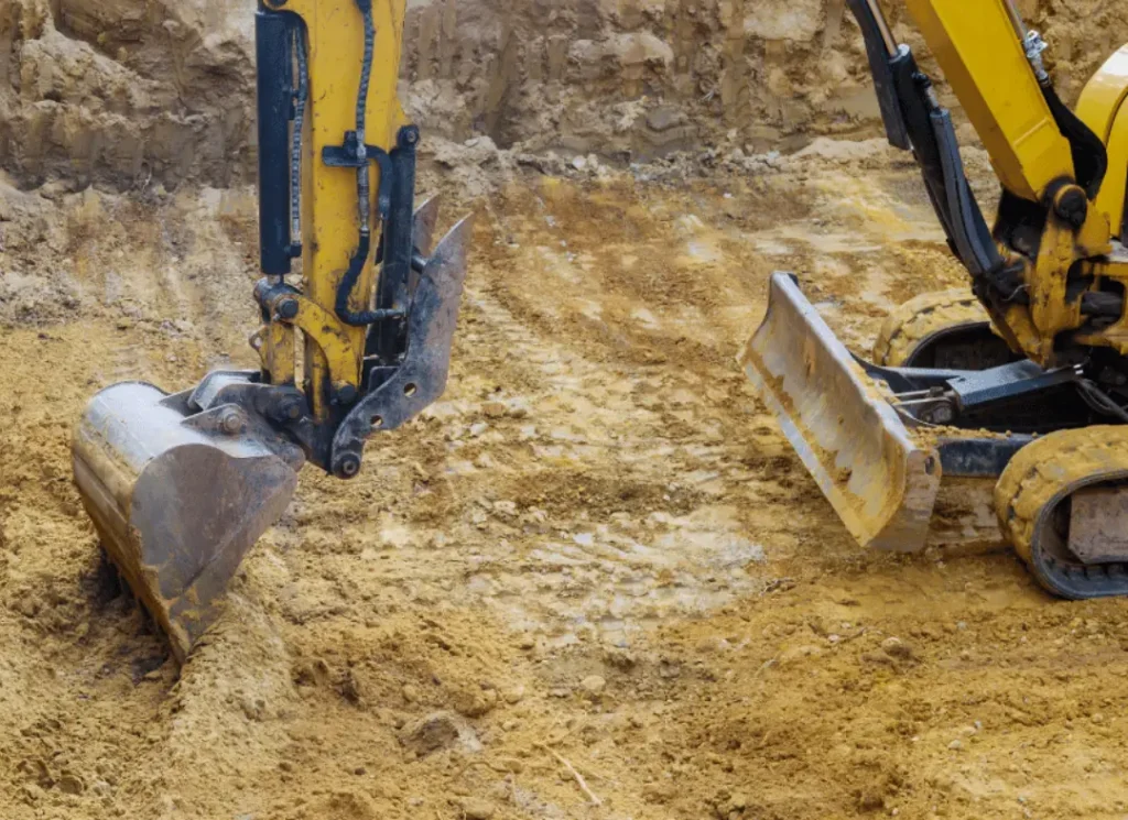 Yellow excavators digging dirt